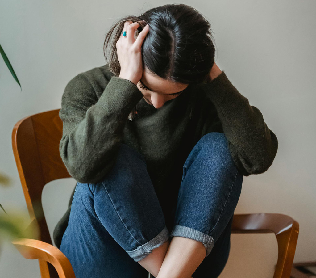 Anxious woman sitting in a folded position