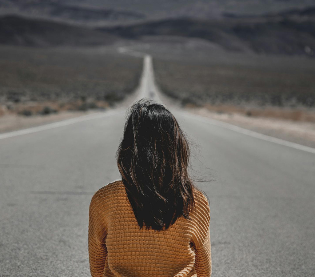 woman sitting on the road to explain life transitions
